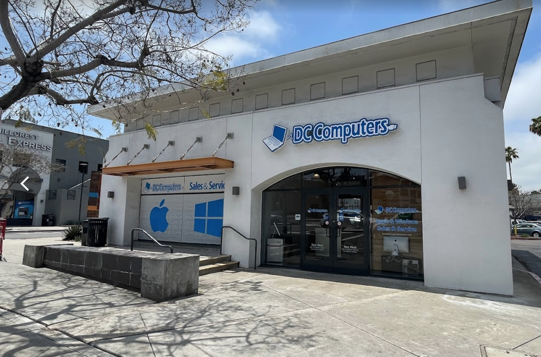 The DC Computers storefront in Hillcrest, San Diego, with Apple and Windows Sales and Service signage in the front windows