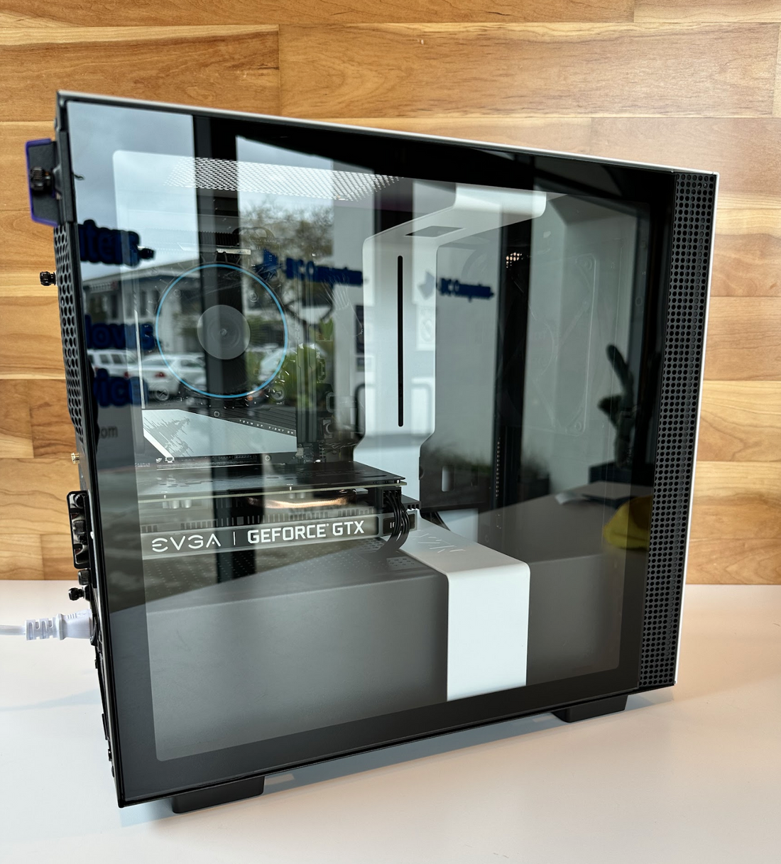 A custom PC with a glass side panel and a NVIDIA GeForce graphics card lit up, on the DC Computers counter in San Diego